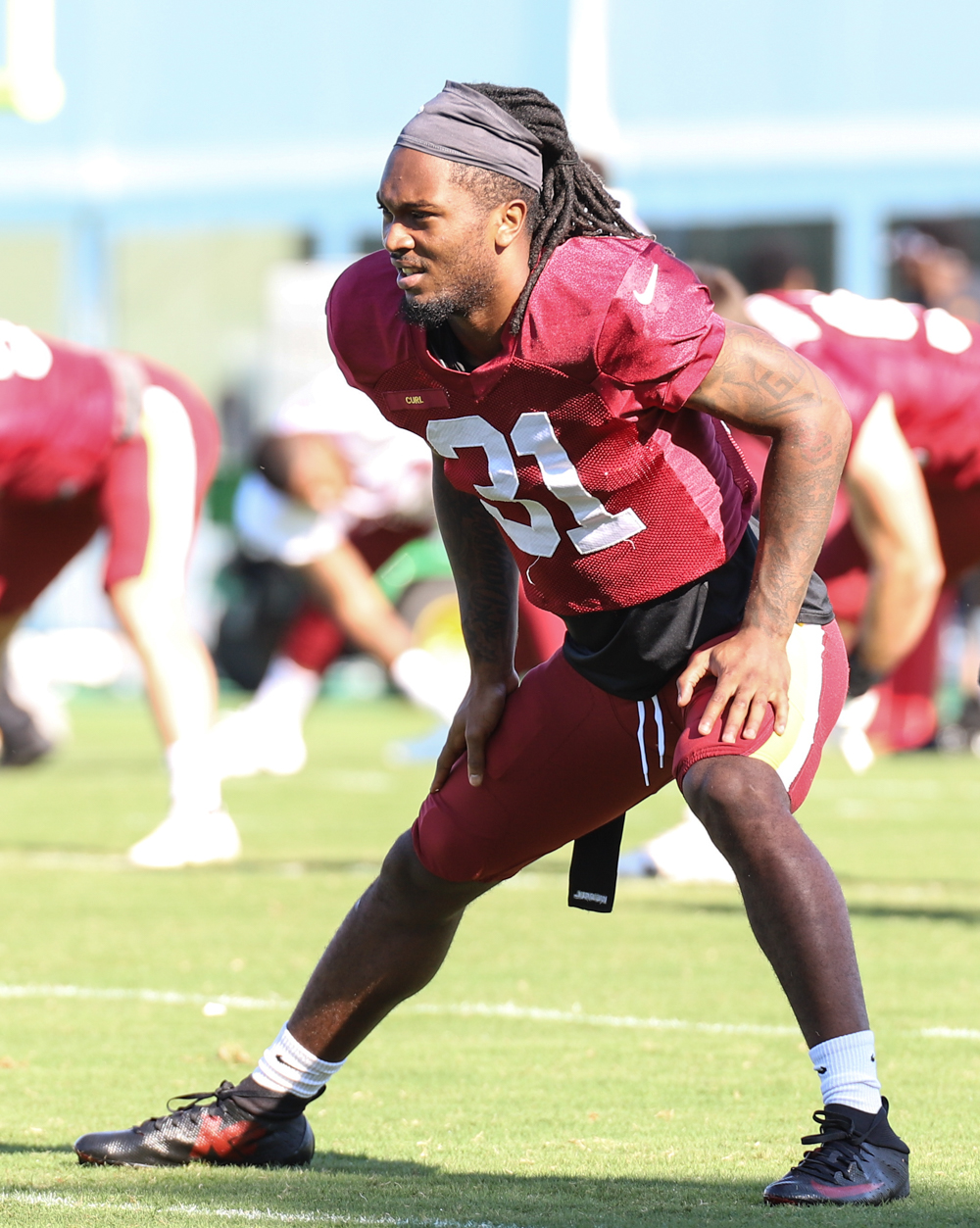 Washington Commanders Safety Kamren Curl (32) doing morning stre