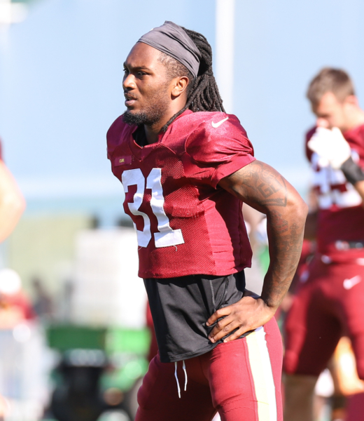 Washington Commanders Safety Kamren Curl (32) doing morning stre
