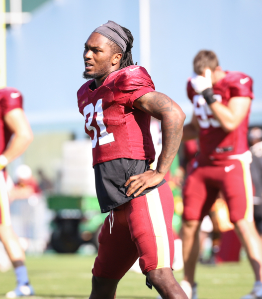 Washington Commanders Safety Kamren Curl (32) doing morning stre