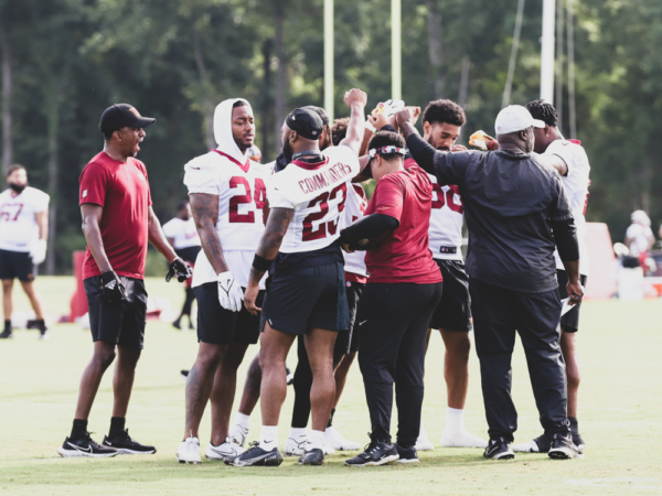 Offensive Team huddles up before breaking off to do stretches at