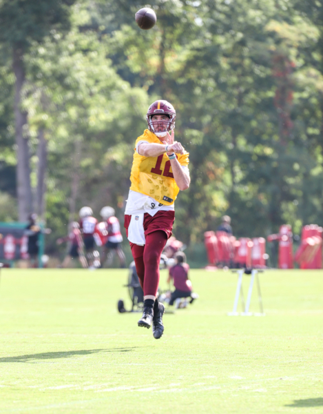 Quarterback Cole Kelley (12) makes a throw at the Commanders tra