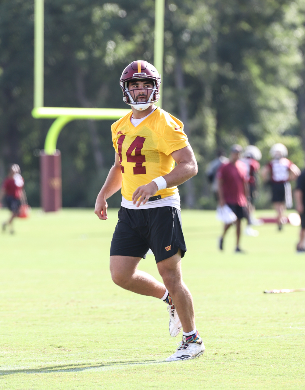 Quarterback Sam Howell (14) makes his way back to formation at t