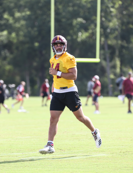 Quarterback Sam Howell (14) after completing a throw during day