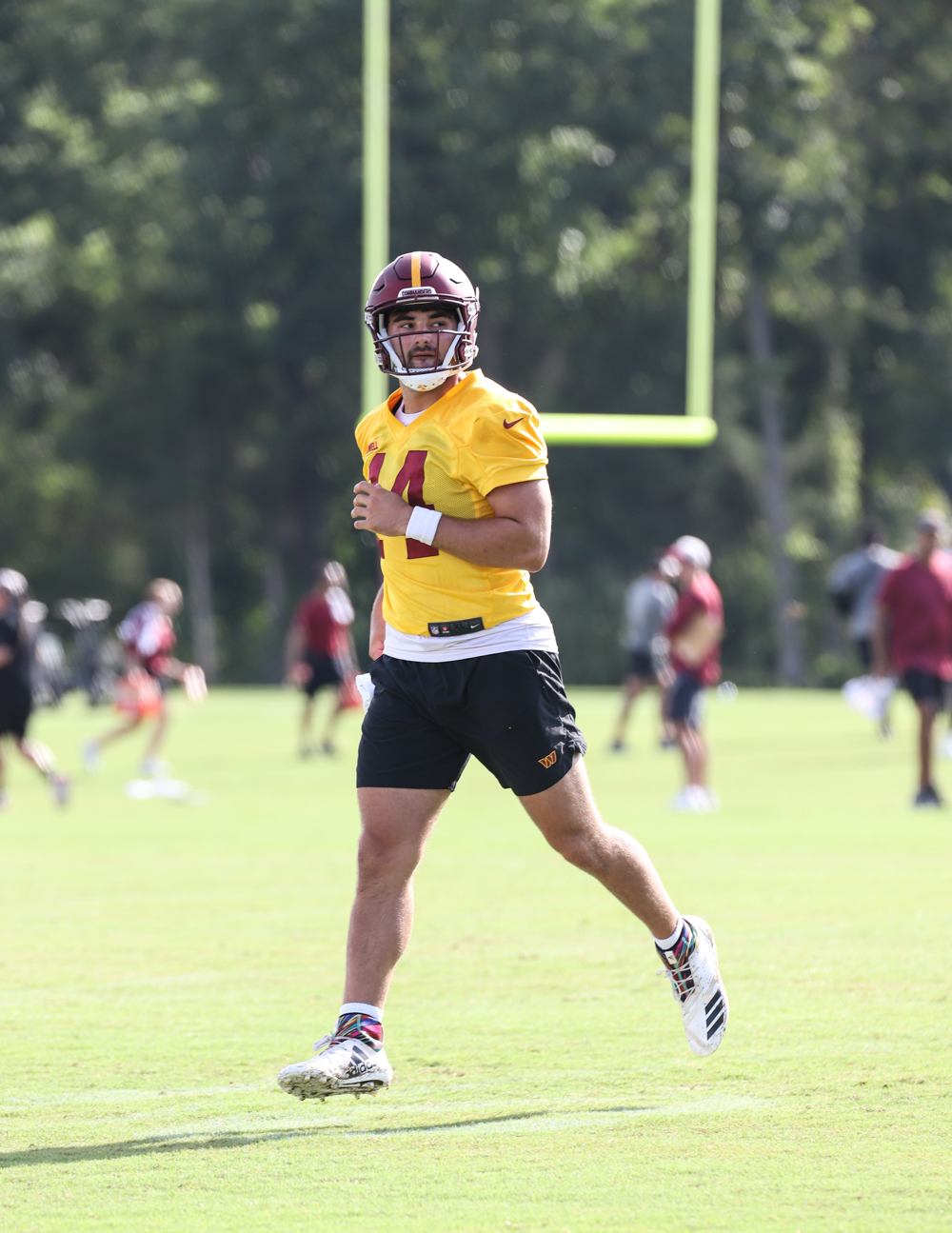 Quarterback Sam Howell (14) after completing a throw during day