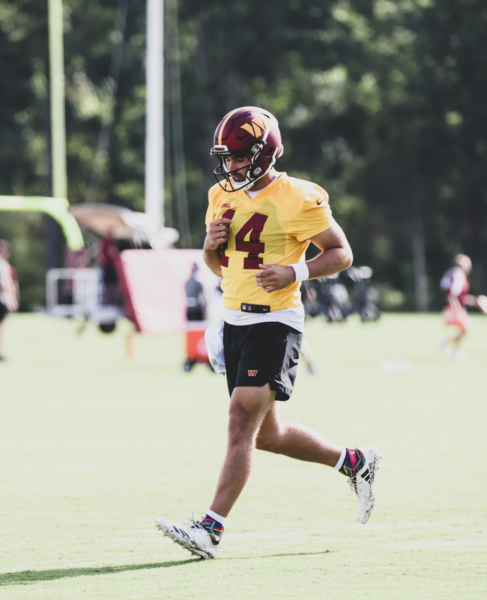 Quarterback Sam Howell (14) makes his way back to formation at t