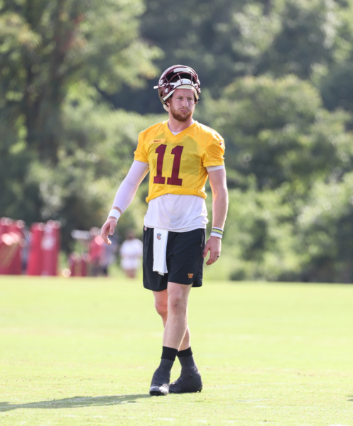 Quarterback Carson Wentz (11) watches from the side at the Comma