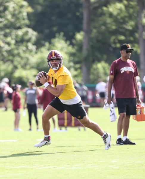 Quarterback Sam Howell (14) prepares to make a throw at the Comm