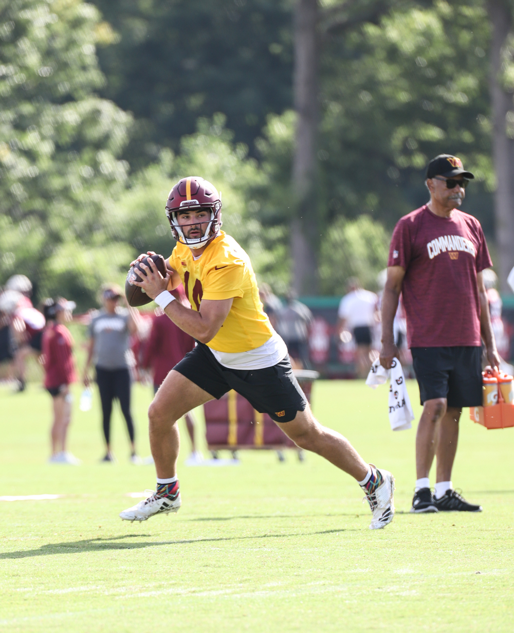 Quarterback Sam Howell (14) prepares to make a throw at the Comm