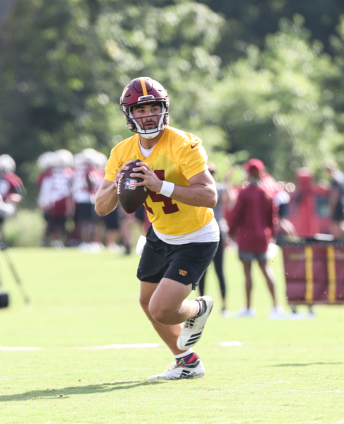 Quarterback Sam Howell (14) prepares to make a throw at the Comm
