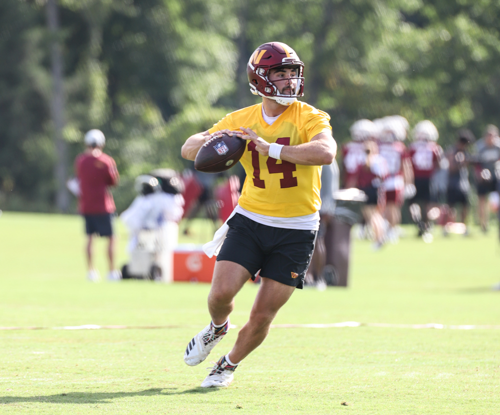 Quarterback Sam Howell (14) prepares to make a throw at the Comm