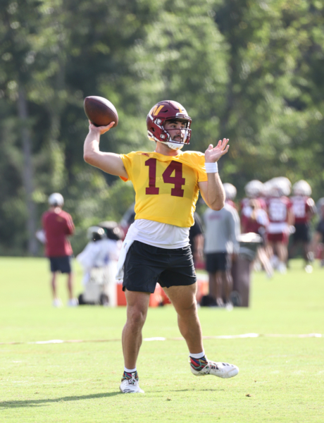 Quarterback Sam Howell (14) prepares to make a throw at the Comm