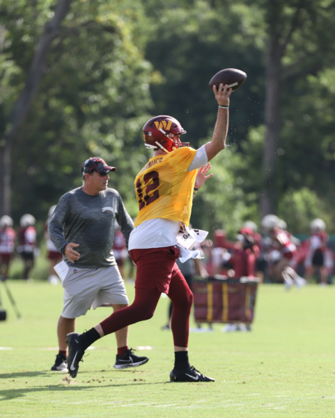 Quarterback Cole Kelley (12) prepares to make a throw at the Com