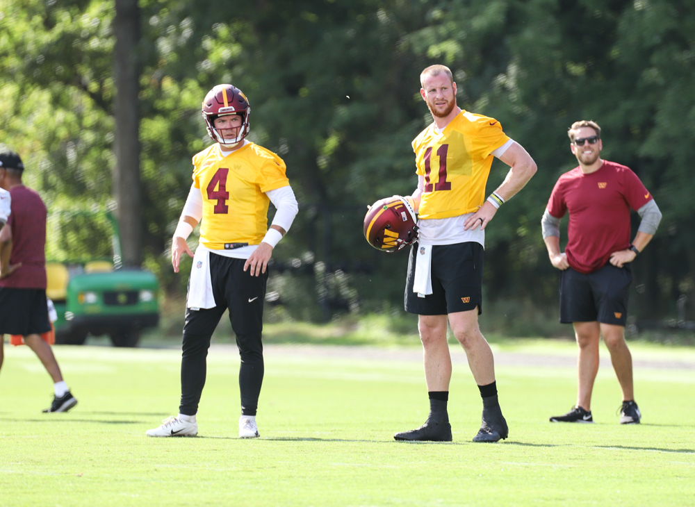 Quarterbacks Taylor Henicke (4) and Carson Wentz (11) chatting a