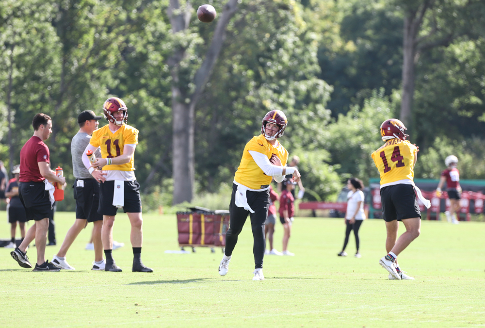 Quarterback Taylor Heinicke (4) makes a throw at the Commanders