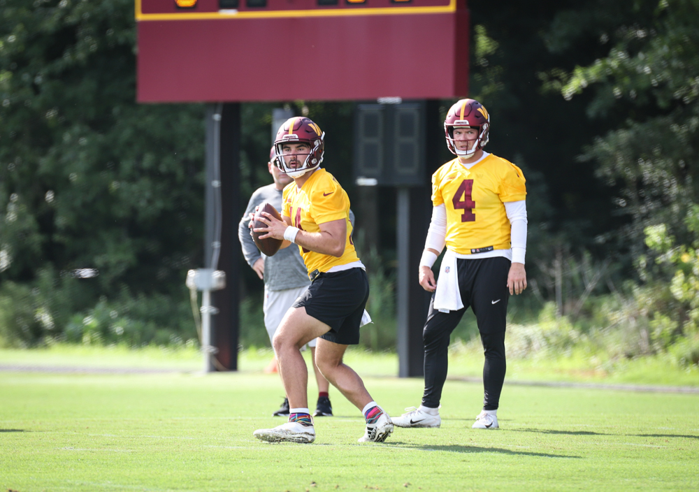 Quarterback Sam Howell (14) prepares to throw the ball as Taylor