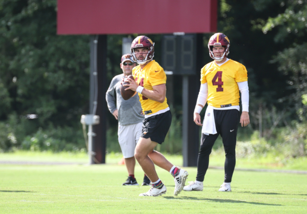 Quarterback Sam Howell (14) prepares to throw the ball as Taylor