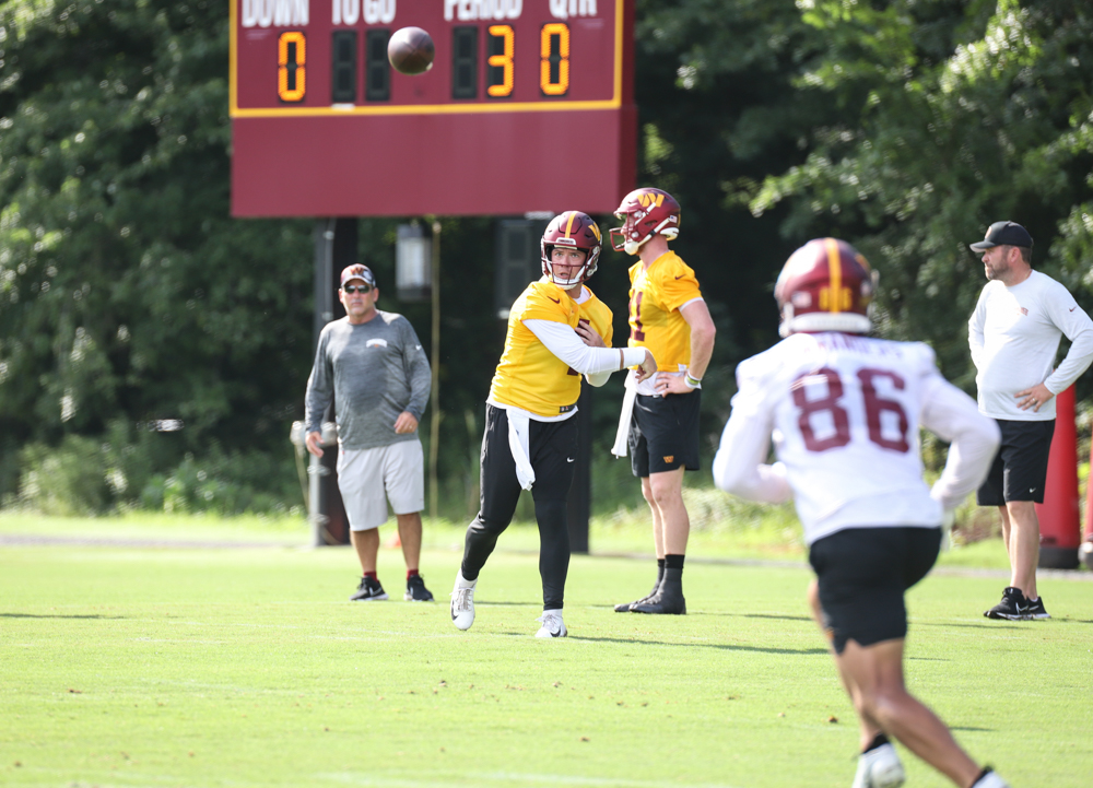Quarterback Taylor Heinicke (4) makes a throw at the Commanders