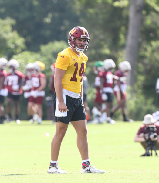 Quarterback Sam Howell (14) watches the play at the Commanders t