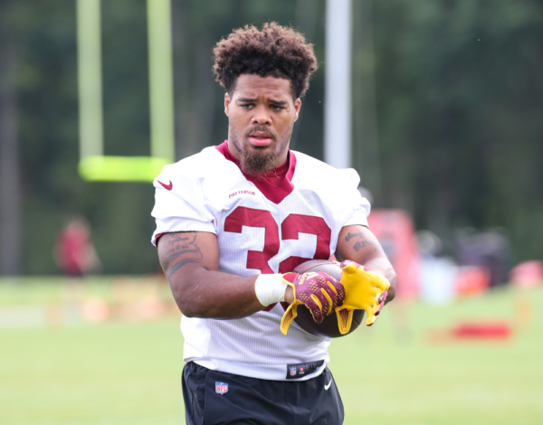 RB Jaret Patterson (32) preparing for practice, putting his glov