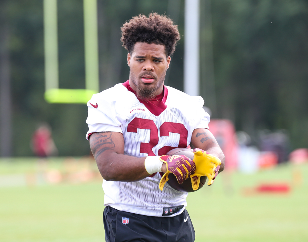 RB Jaret Patterson (32) preparing for practice, putting his glov