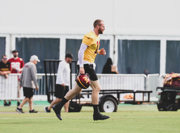 Quarterback Carson Wentz (11) takes the field before practice at