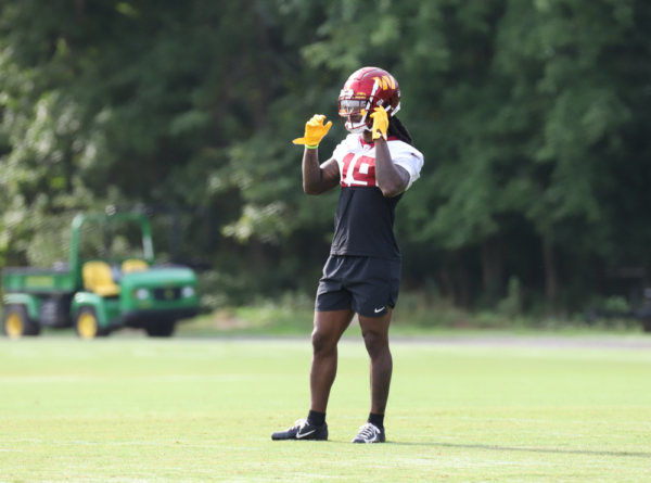 WR Marken Michel (19) adjusts his helmet` during the Commanders