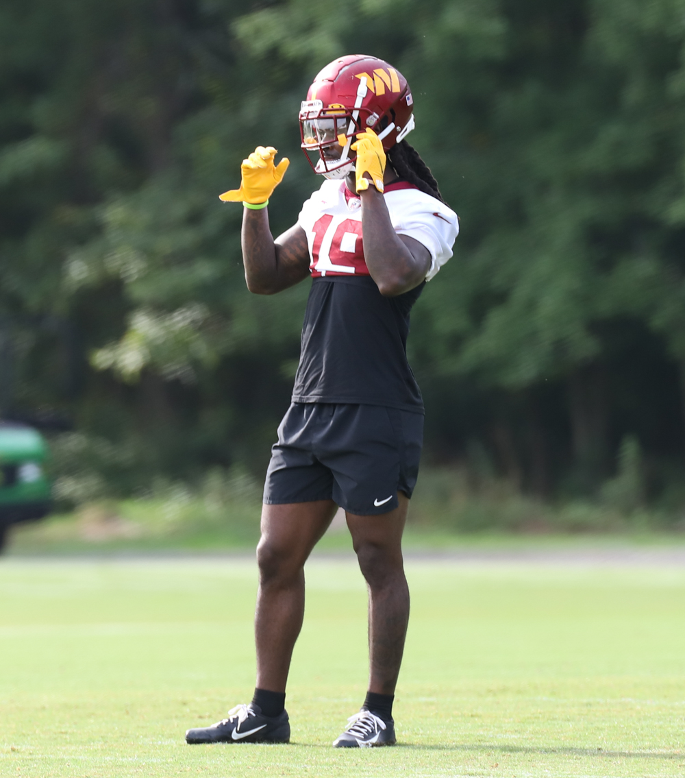 WR Marken Michel (19) adjusts his helmet during the Commanders
