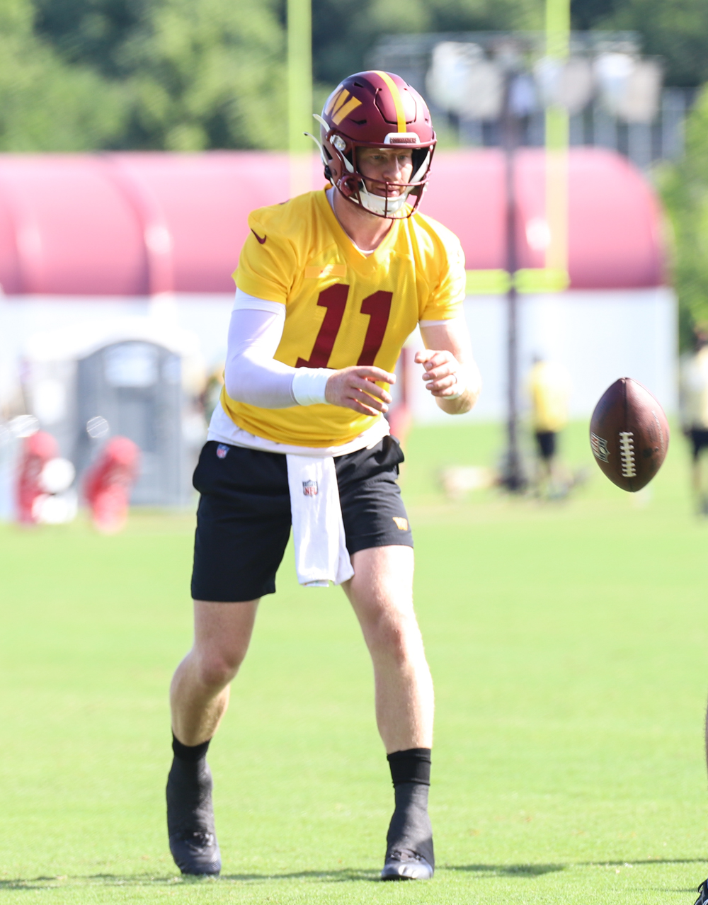 Washington Commanders Quarterback Carson Wentz (11) gets the bal