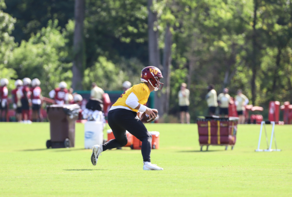 Washington Commanders Quarterback Taylor Heinicke (4) running pl