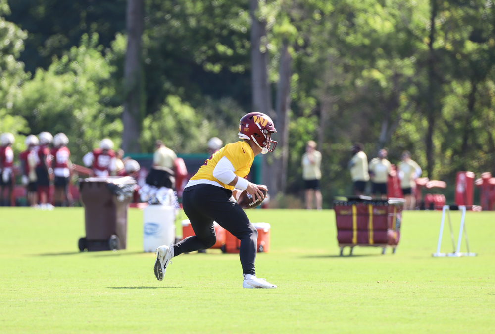Washington Commanders Quarterback Taylor Heinicke (4) running pl
