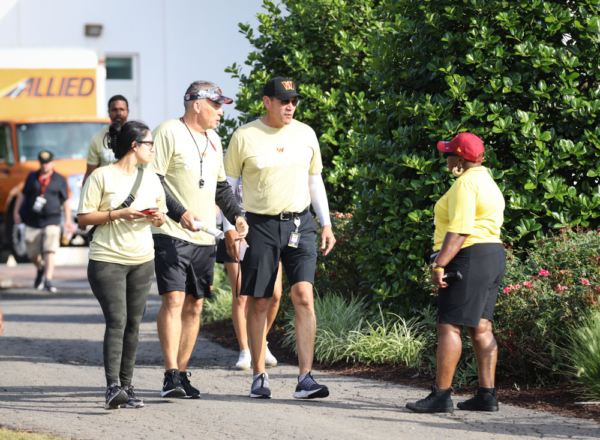 Washington Commanders Head Coach Ron Rivera greets a grounds wor