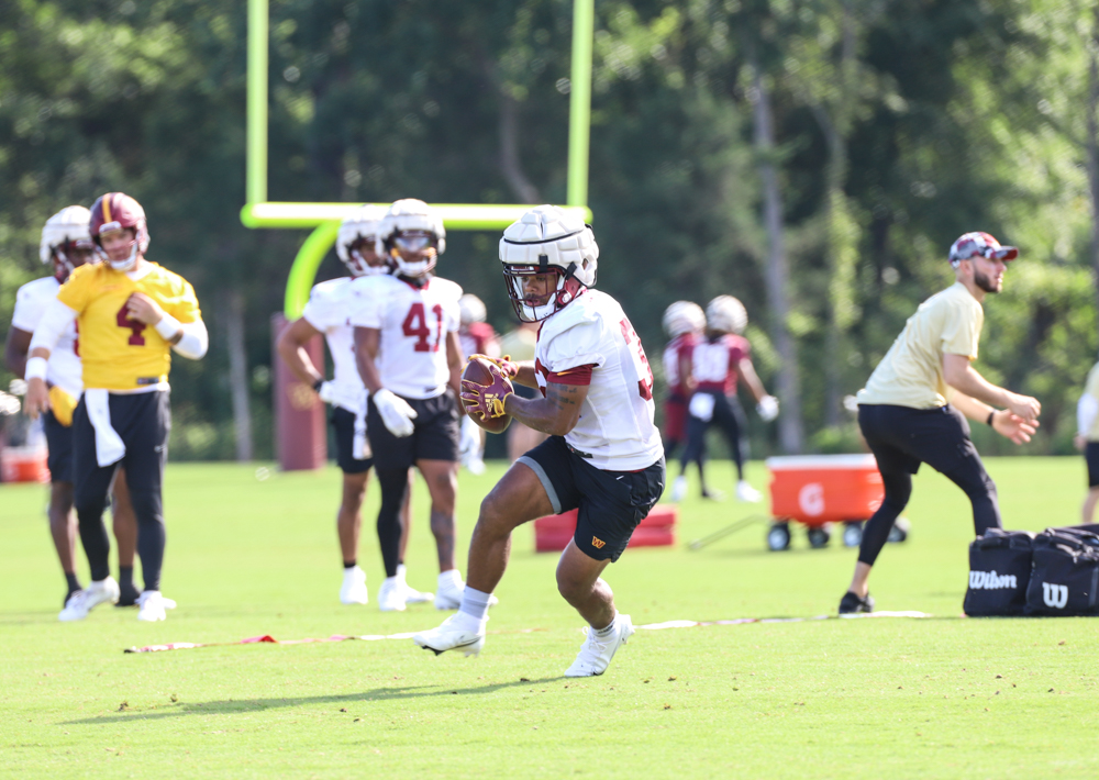 Washington Commanders Running Back Jaret Patterson (32)makes a c