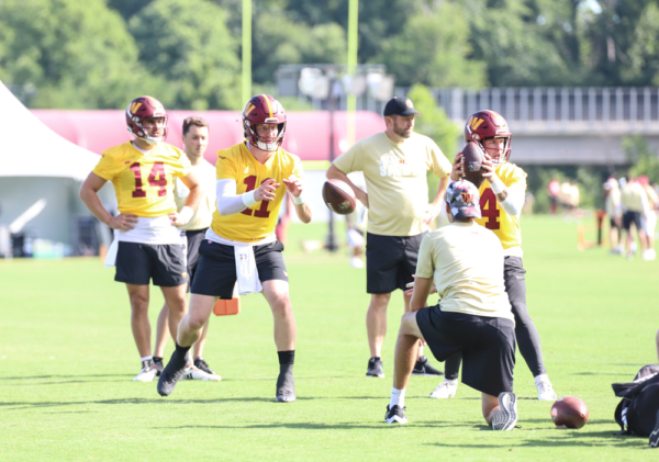 Washington Commanders Quarterback Carson Wentz (11) gets the bal